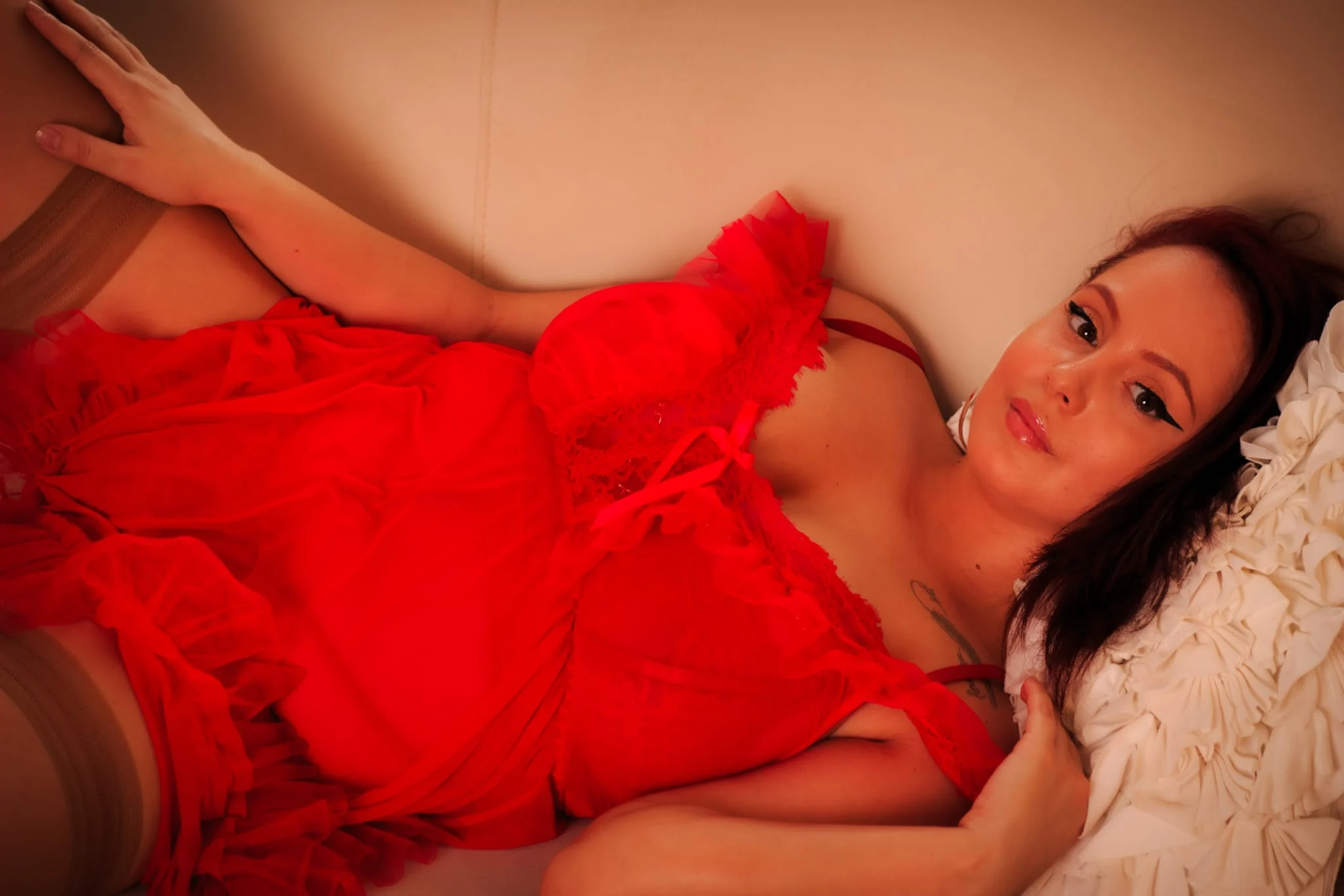 camille on bed in pink robe